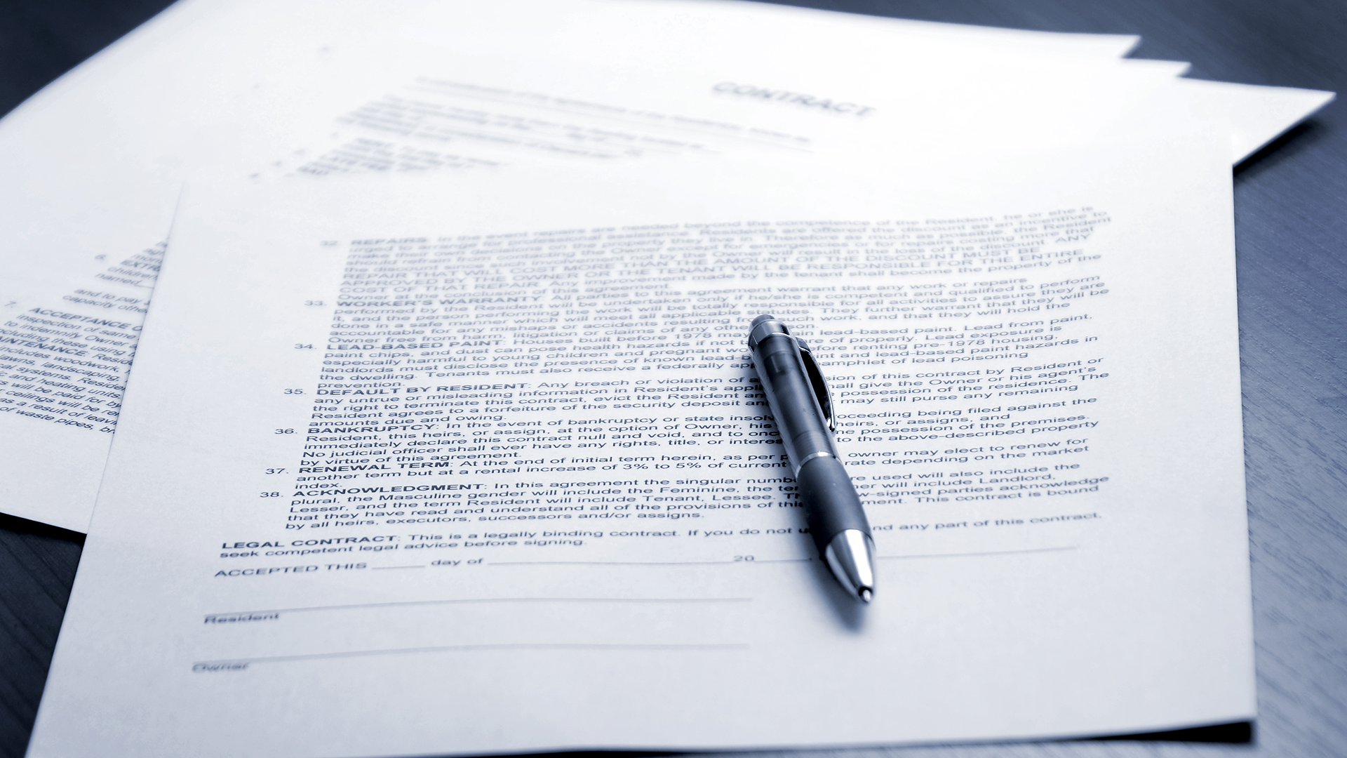 Pen on legal documents, ready for signing.